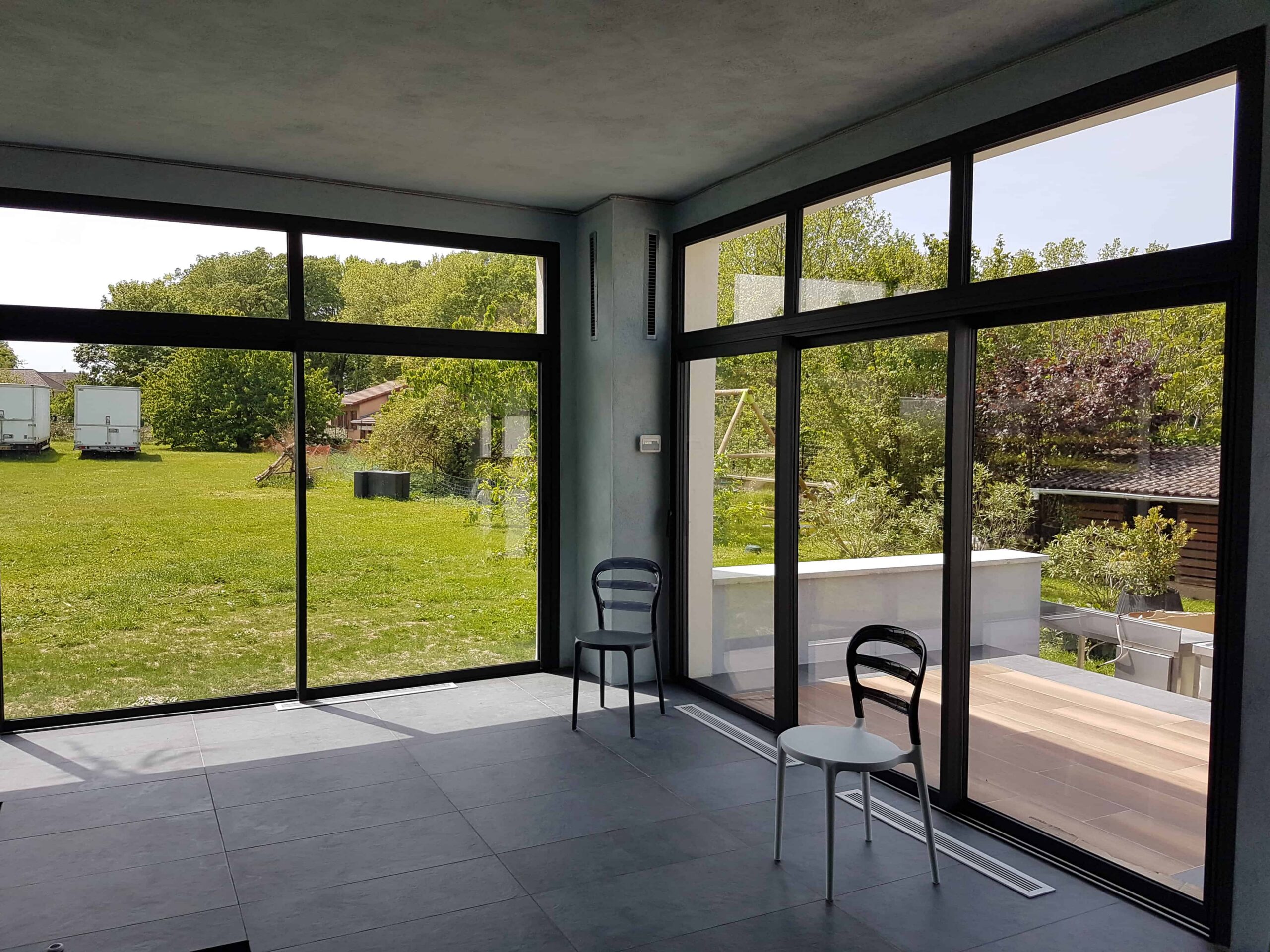 Installation de baies vitrées coulissantes en aluminium dans une maison moderne